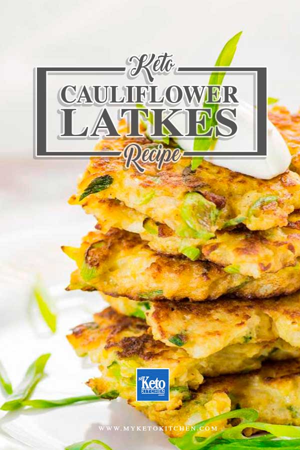 Low Carb Cauliflower Latkes stacked on a plate and topped with sour cream