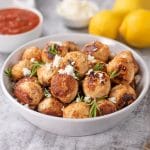 Keto Chicken Feta Meatballs in a white bowl sprinkled with feta and rosemary
