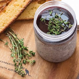 Keto Mushroom Pate on a wooden board with crispy low carb bread