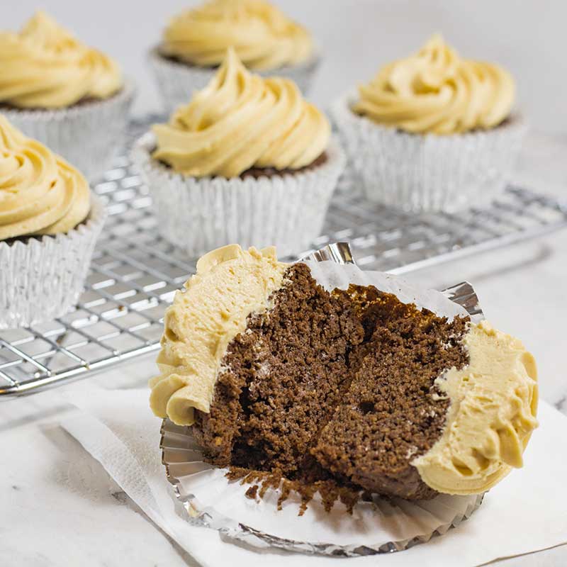 Keto Chocolate Peanut Butter Cupcake cut in half showing the soft, fluffy cake center