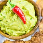 Keto guacamole in a wooden dipping bowl.