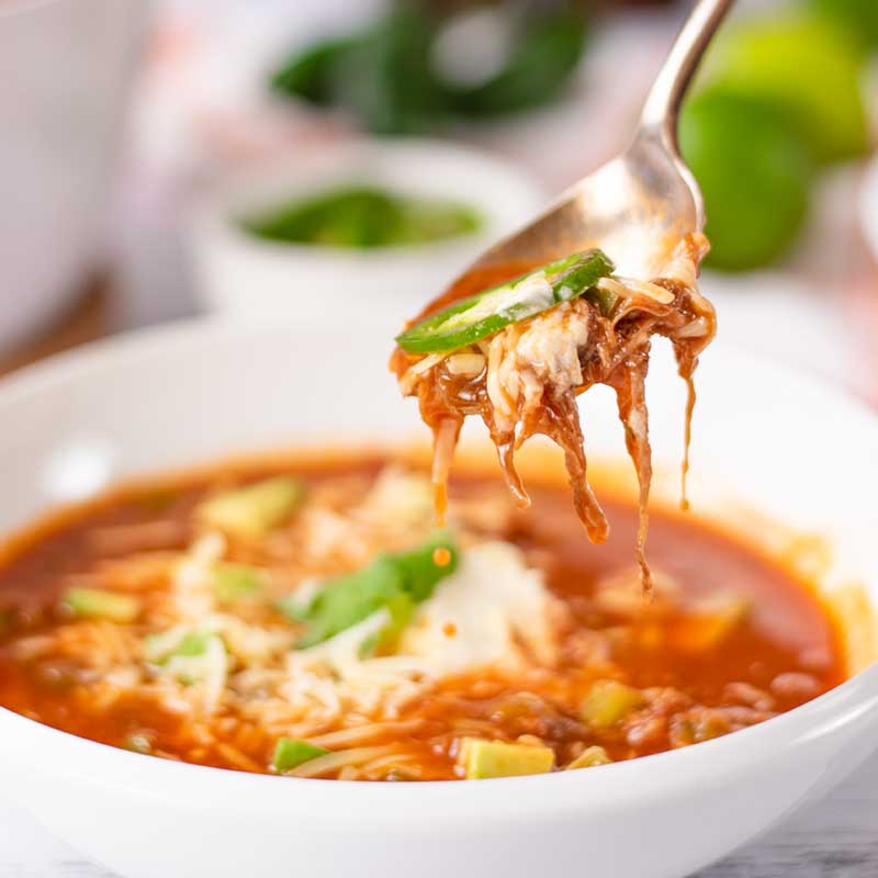 Keto Taco Soup being spooned from a bowl