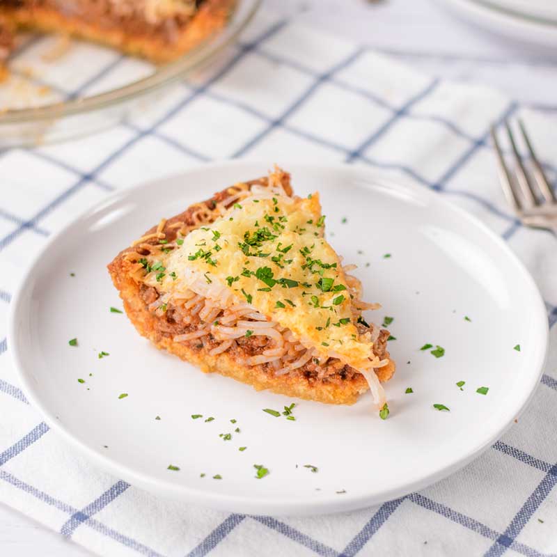 A slice of Keto Spaghetti Bolognese Pie on a plate