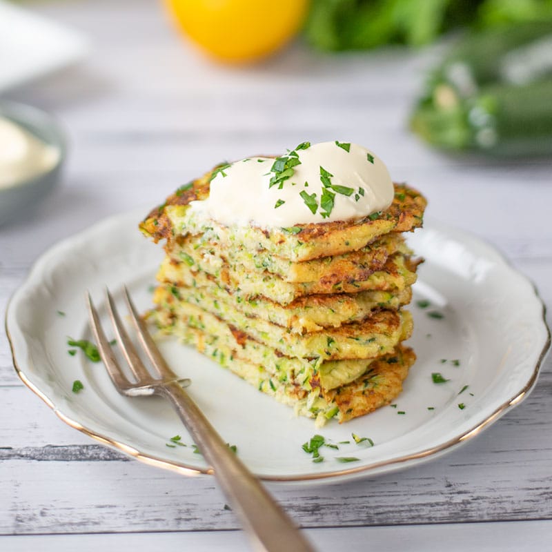 Keto Zucchini Fritters on a plate with a slice cut off the left side