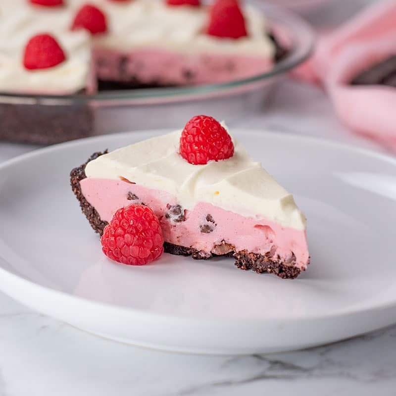 Keto Raspberry Cream Pie slice on a plate