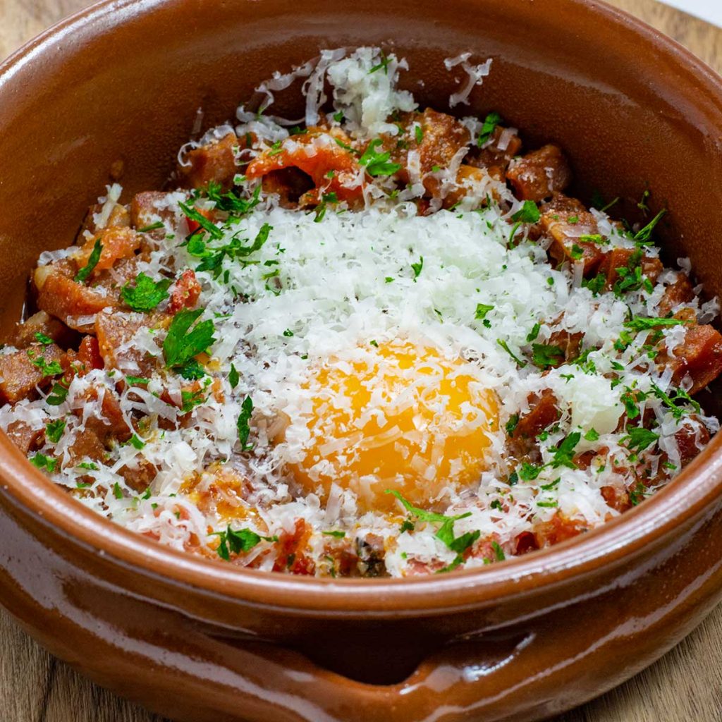 Spanish Baked Eggs ingredients in a tapas dish.