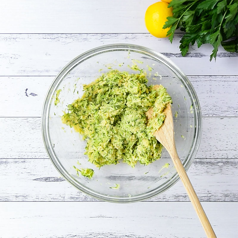 Keto Zucchini Fritters Ingredients mixed in a glass bowl