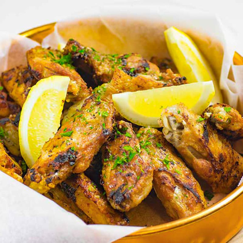 Pan fried keto chickens wings recipe being served in a copper bowl.