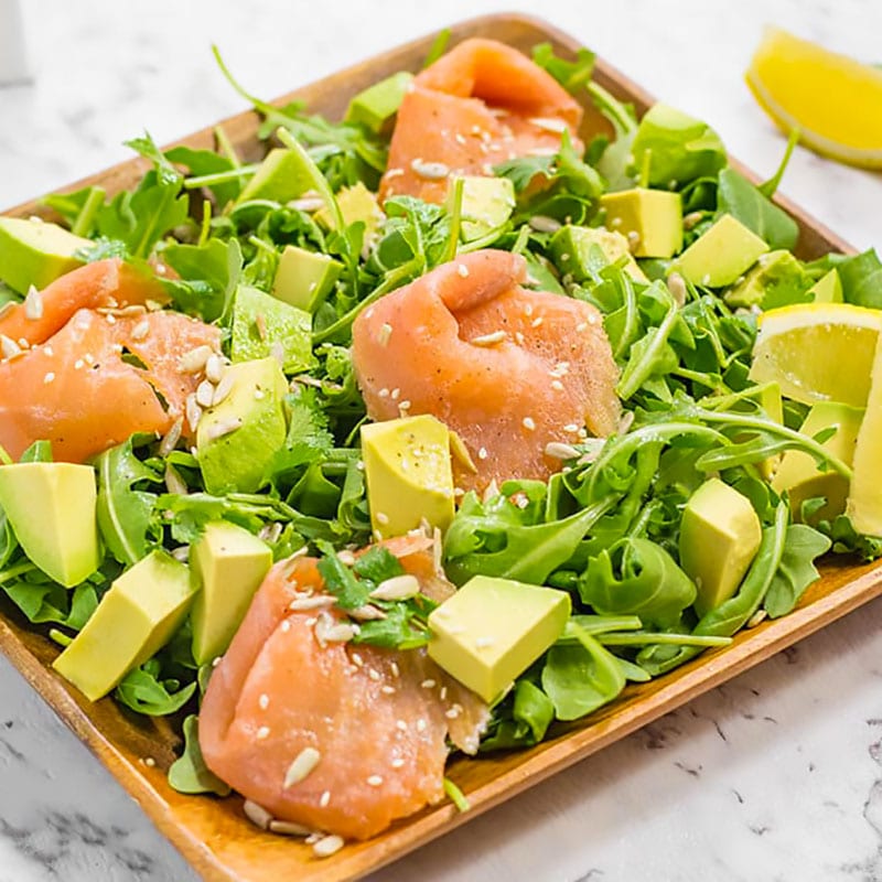 Smoked salmon and avocado salad in a brown salad bowl.