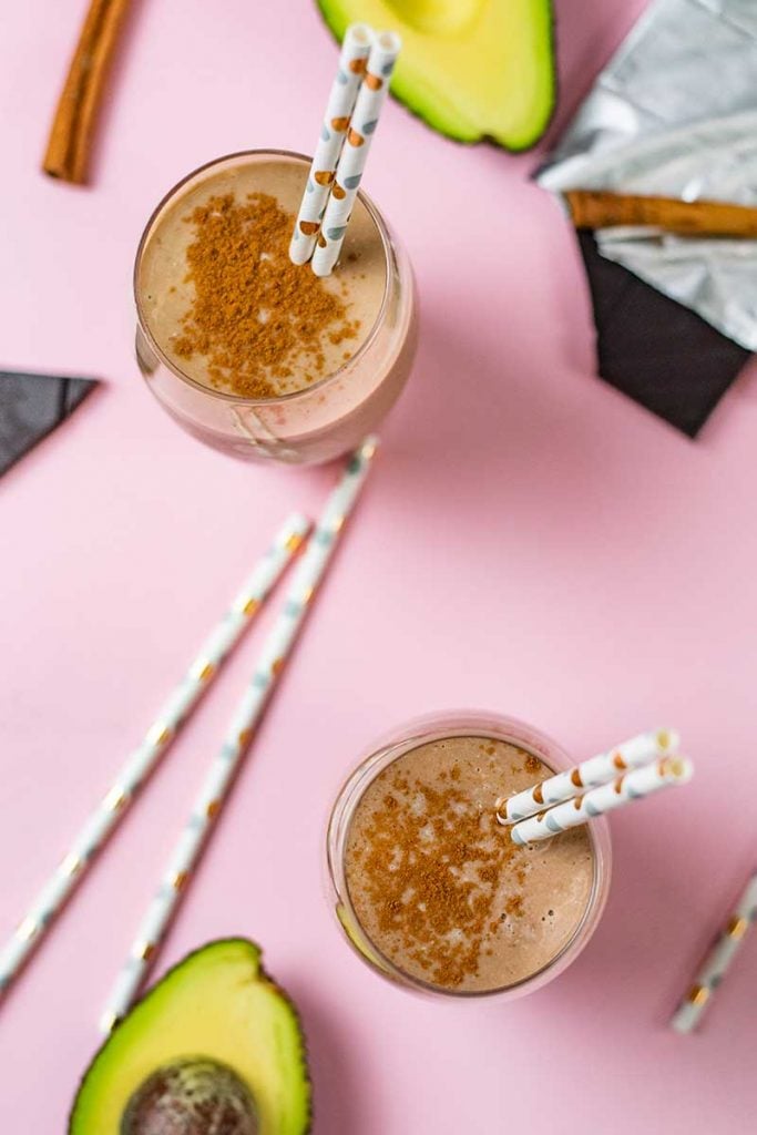 Keto Chocolate Avocado Smoothie in a glass on a pink table