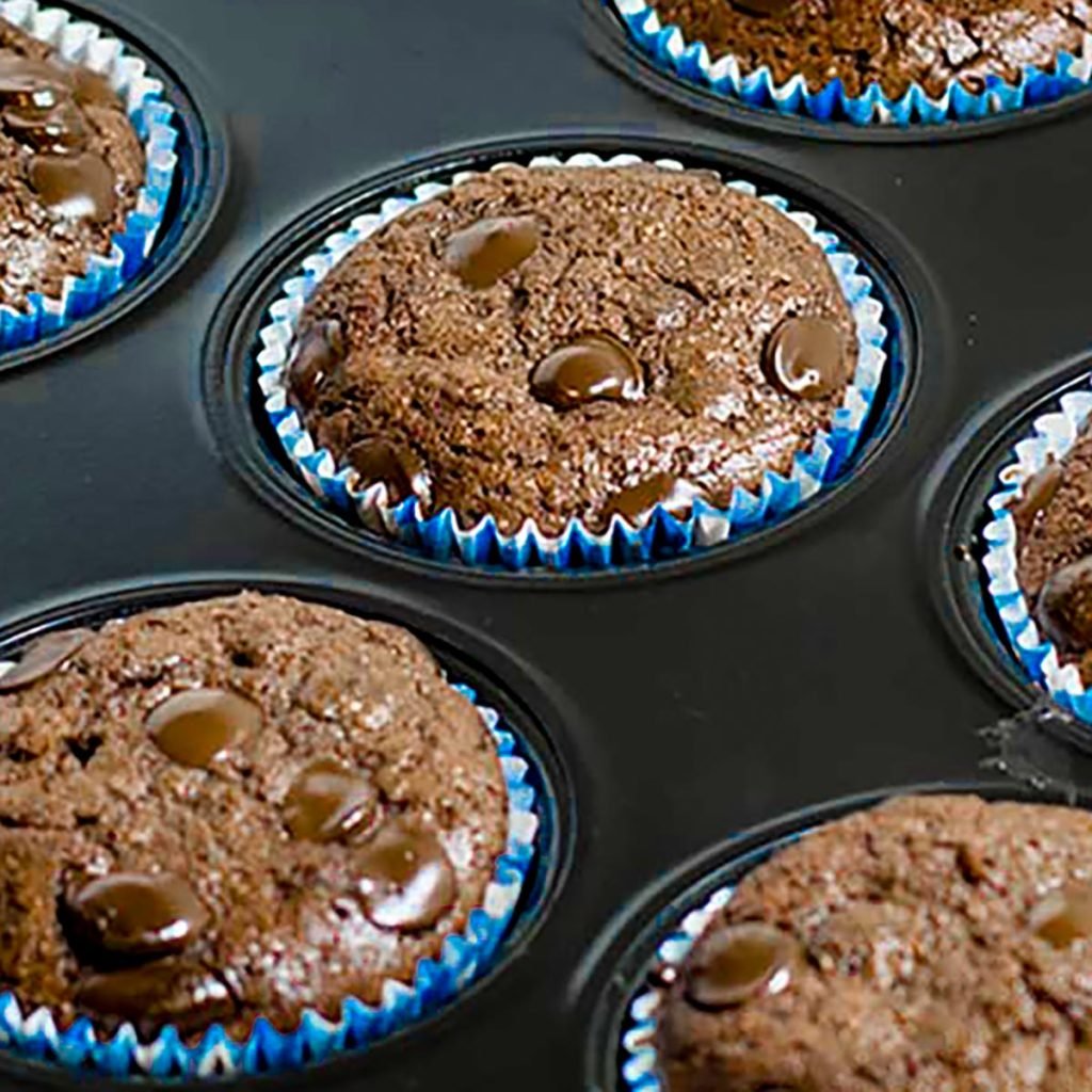 Keto chocolate muffins in a muffin tin.