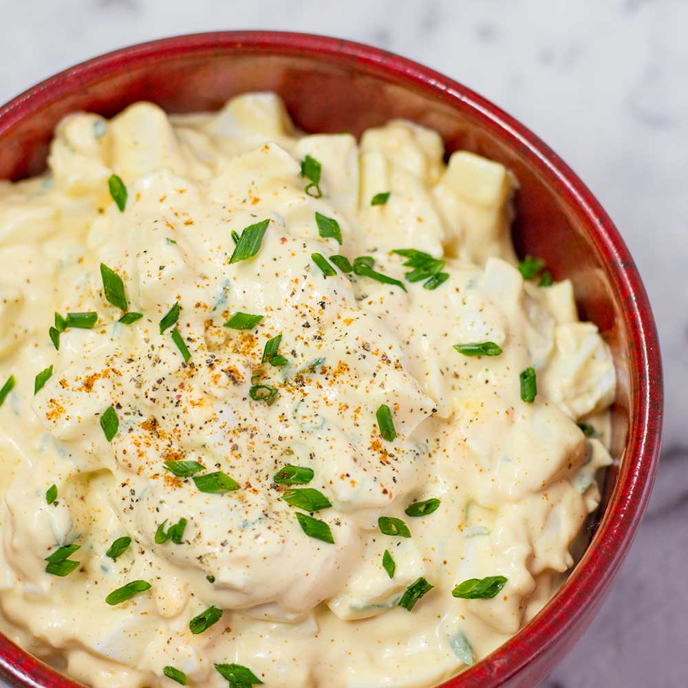 Keto egg salad in a red bowl.