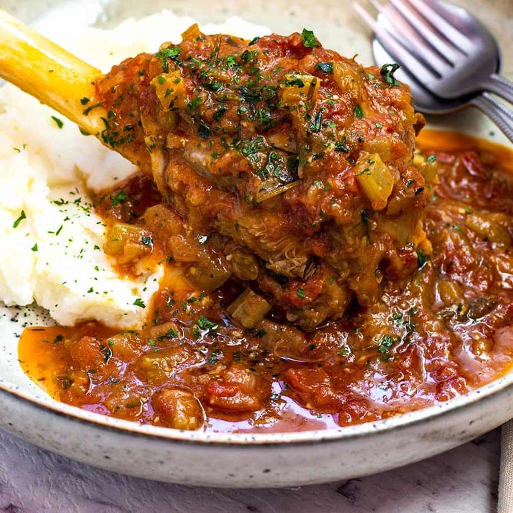 Keto lamb shanks in a bowl with cauliflower mash.