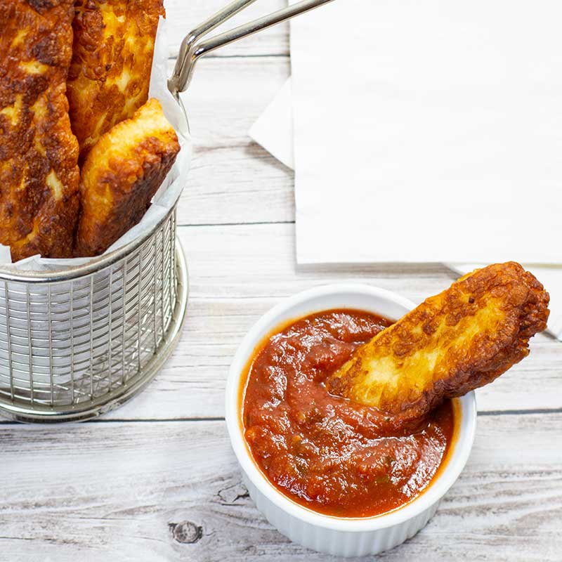 Keto Halloumi Fries dipped in Keto Marinara Sauce