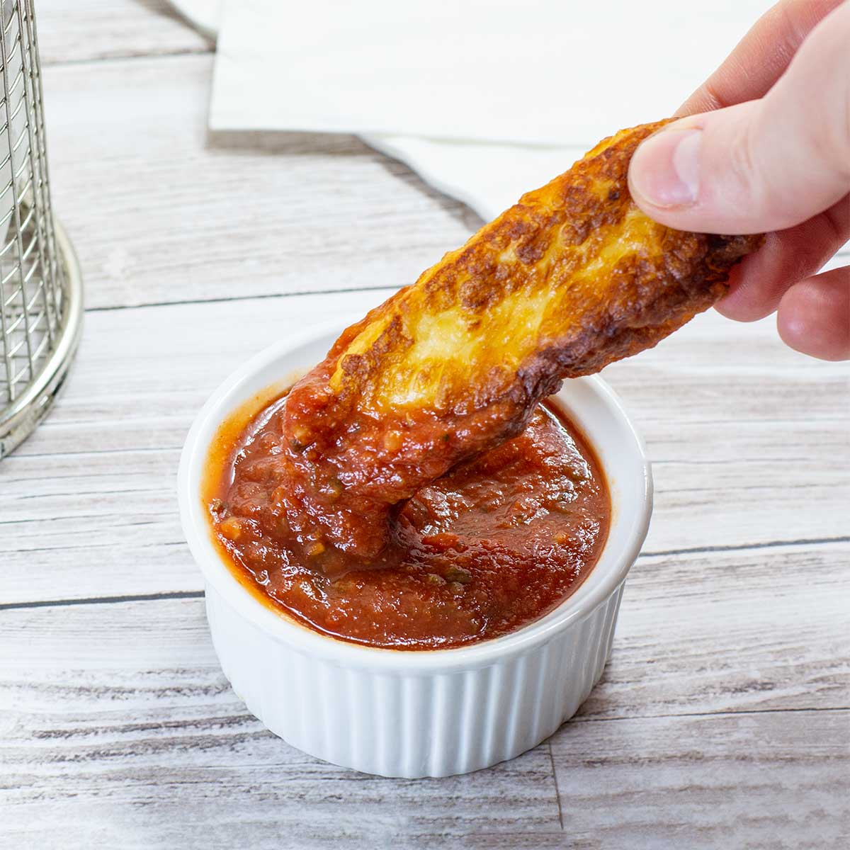 Keto Halloumi Fries dipped in Keto Marinara Sauce