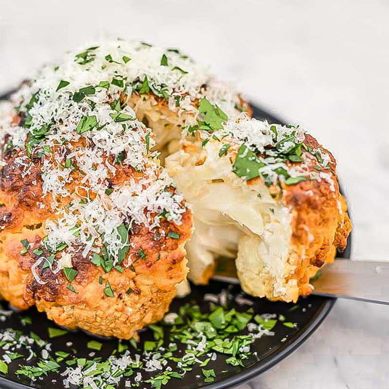 Whole roasted cauliflower with garlic and cheese.