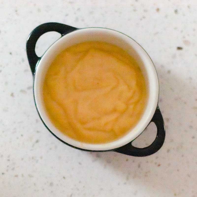 Image shows the raw keto 90 second bread batter in a white ramekin with grey handles
