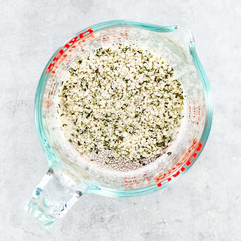 Keto overnight oats ingredients in a measuring jug.