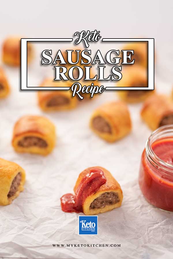 Image shows bite sized keto sausage rolls sitting on crumpled paper, one is drizzle with tomato ketchup.