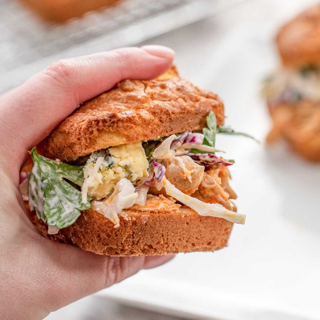 A Keto Buffalo Chicken Slider held up to the camera with a white background