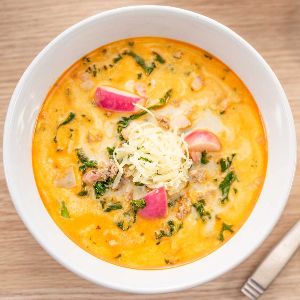 Keto Zuppa Toscana Soup in a white bowl on a wooden table