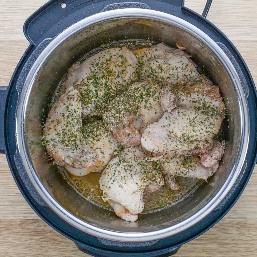 Chicken thighs cover in ranch spice mix in an instant pot for Keto Buffalo Chicken Sliders