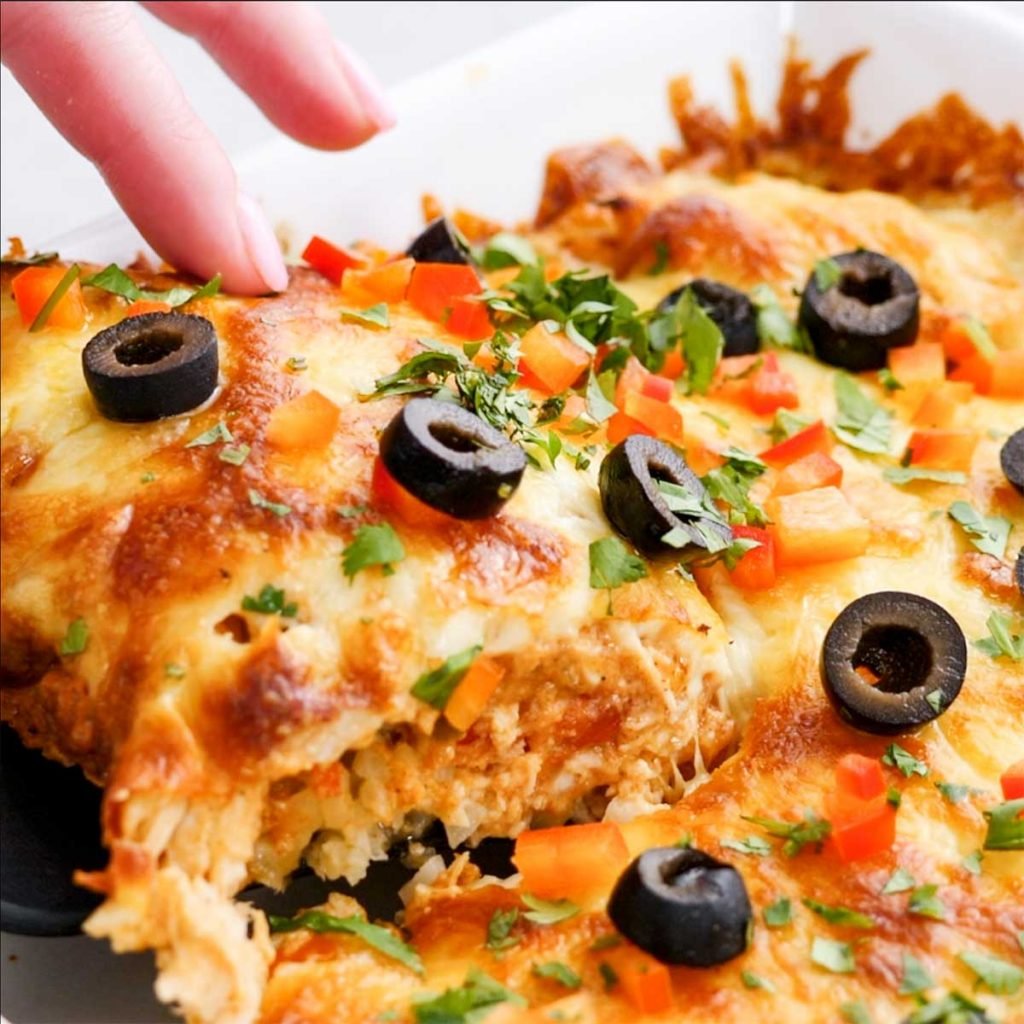 A slice of keto chicken enchilada casserole being lifted