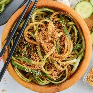 Keto Cucumber Salad in a wooden bowl with chopsticks resting on the side