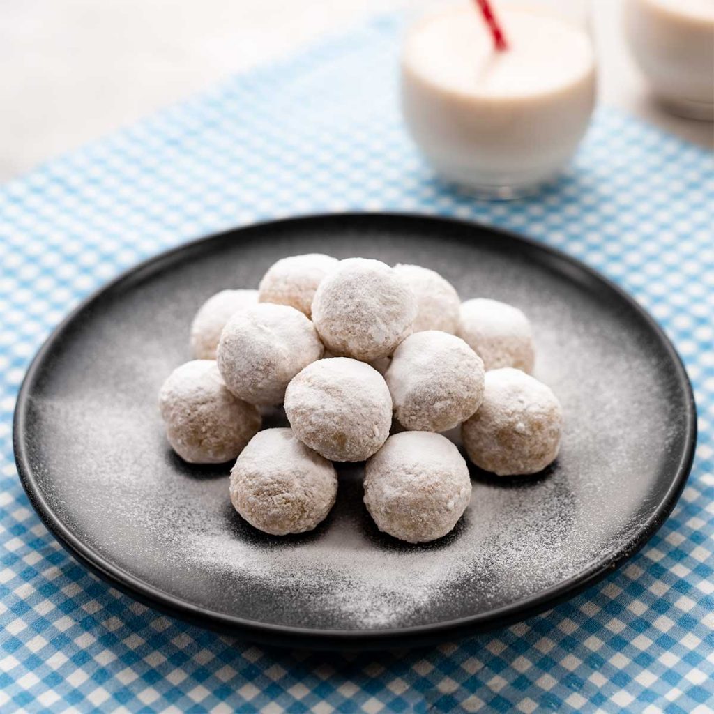 Keto Snowball Cookies on a black plate