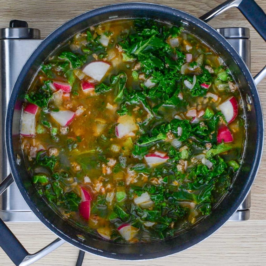 Keto Zuppa Toscana Soup in a black saucepan on the stove