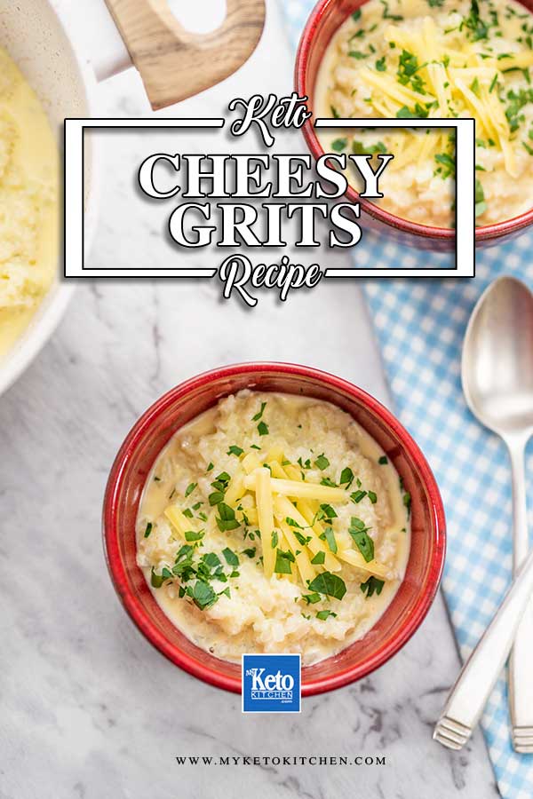 Keto Cheesy Grits in a red bowl, topped with cheddar cheese and chopped parsley