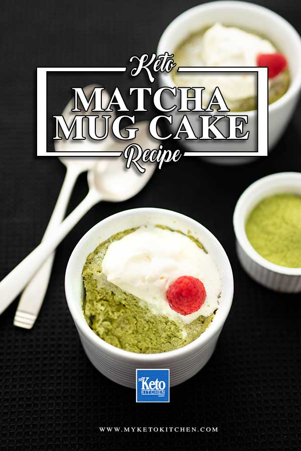 Keto Matcha Mug Cake topped with cream and a raspberry with a spoonful removed in a white ramekin on a black background