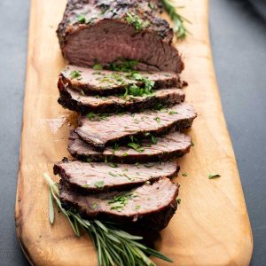 Sliced Grilled Tri Tip on a wooden board