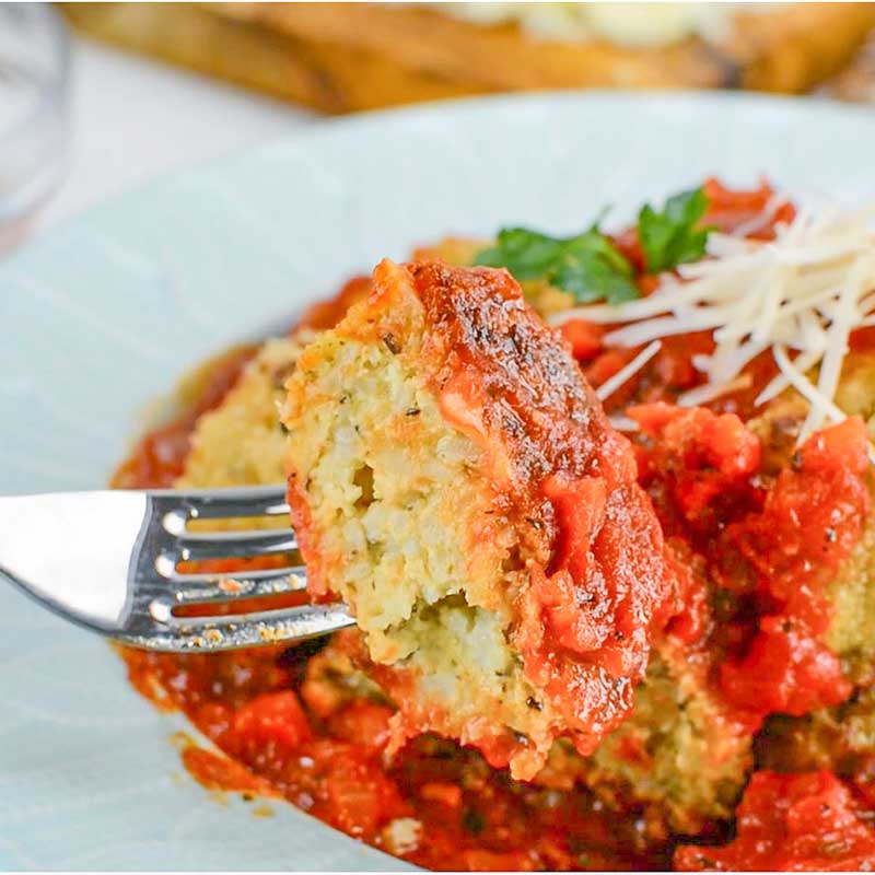 Keto Arancini Balls in a bowl with marinara sauce