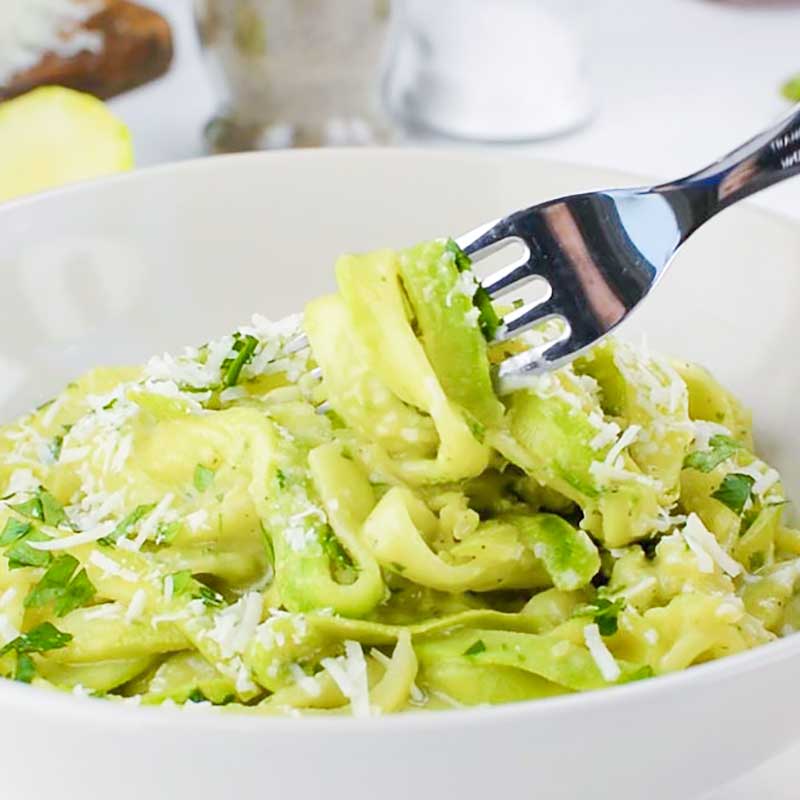 Keto Zoodles wtih Avocado sauce in a white bowl