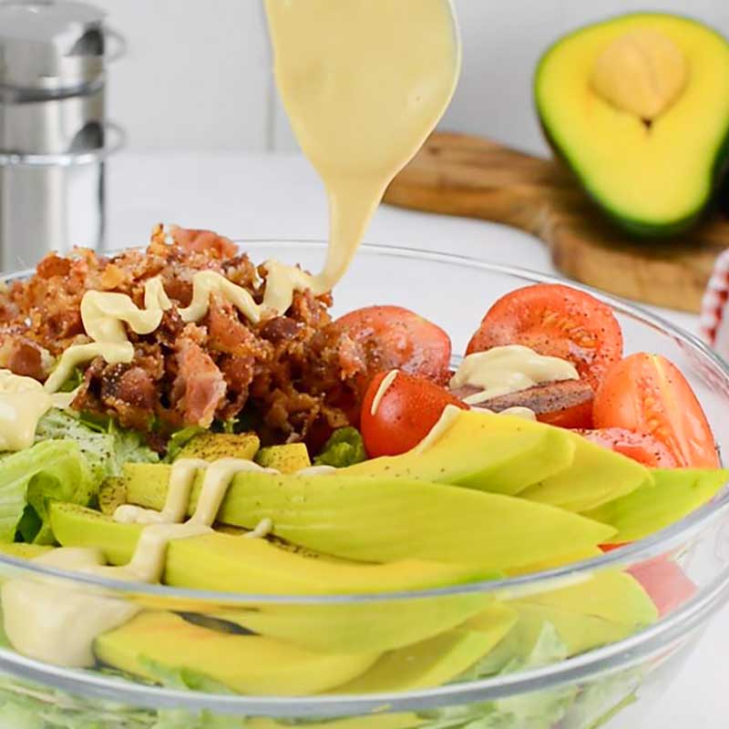 BLT Salad in a bowl drizzled with Garlic Aioli