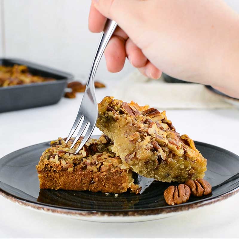 Keto Pecan Bars on a black plate on a white table