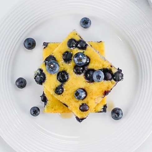 Keto Sheet Pan Pancakes with blueberries on a white plate