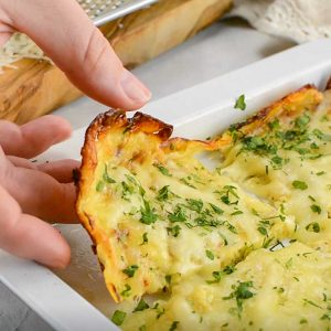 Keto Zucchini Breadsticks being lifted from the pan