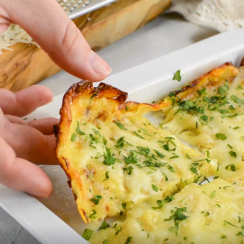 Keto Zucchini Breadsticks being lifted from the pan