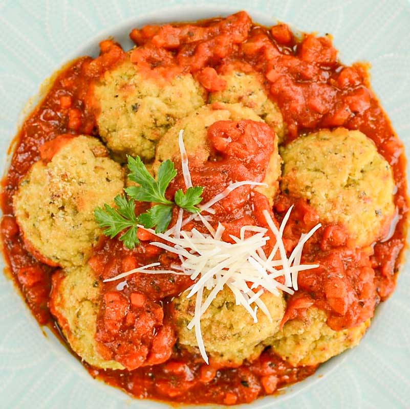 Keto Arancini Balls in a bowl with marinara sauce