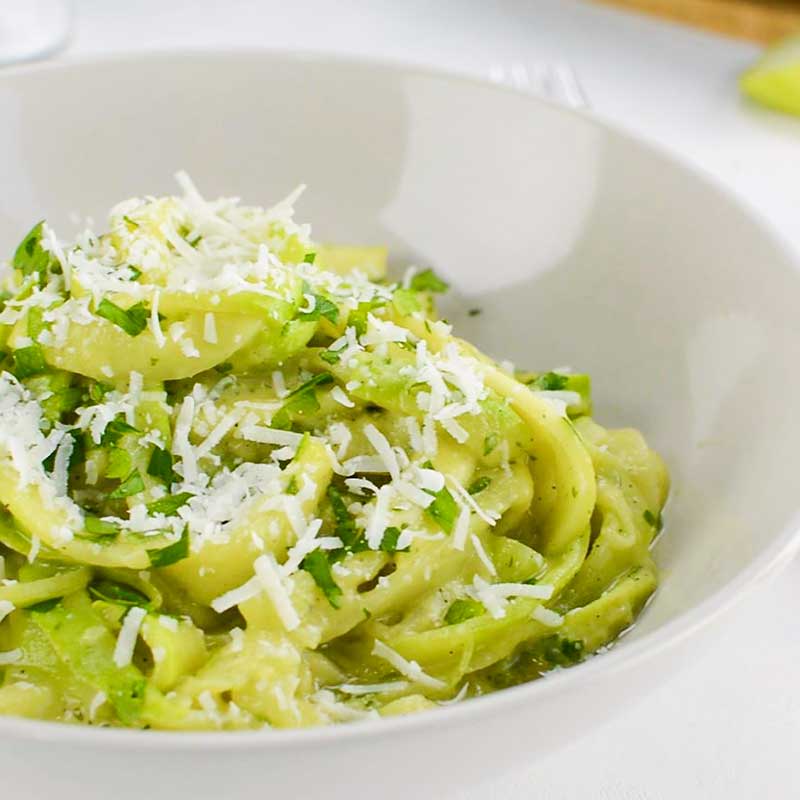 Zoodles wtih Avocado sauce in a white bowl