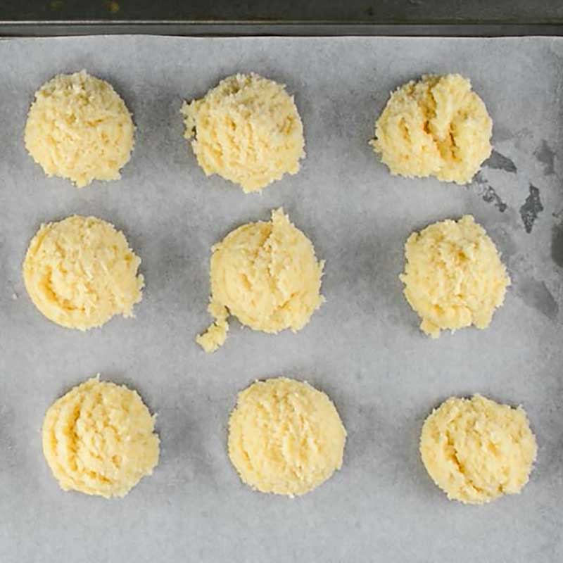 Raw Keto Coconut Macaroons on a lined cookie sheet