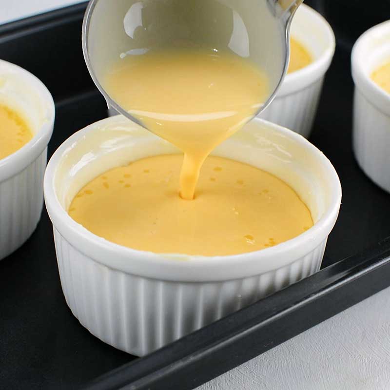 Keto Flan Ingredients being ladled into a ramekin