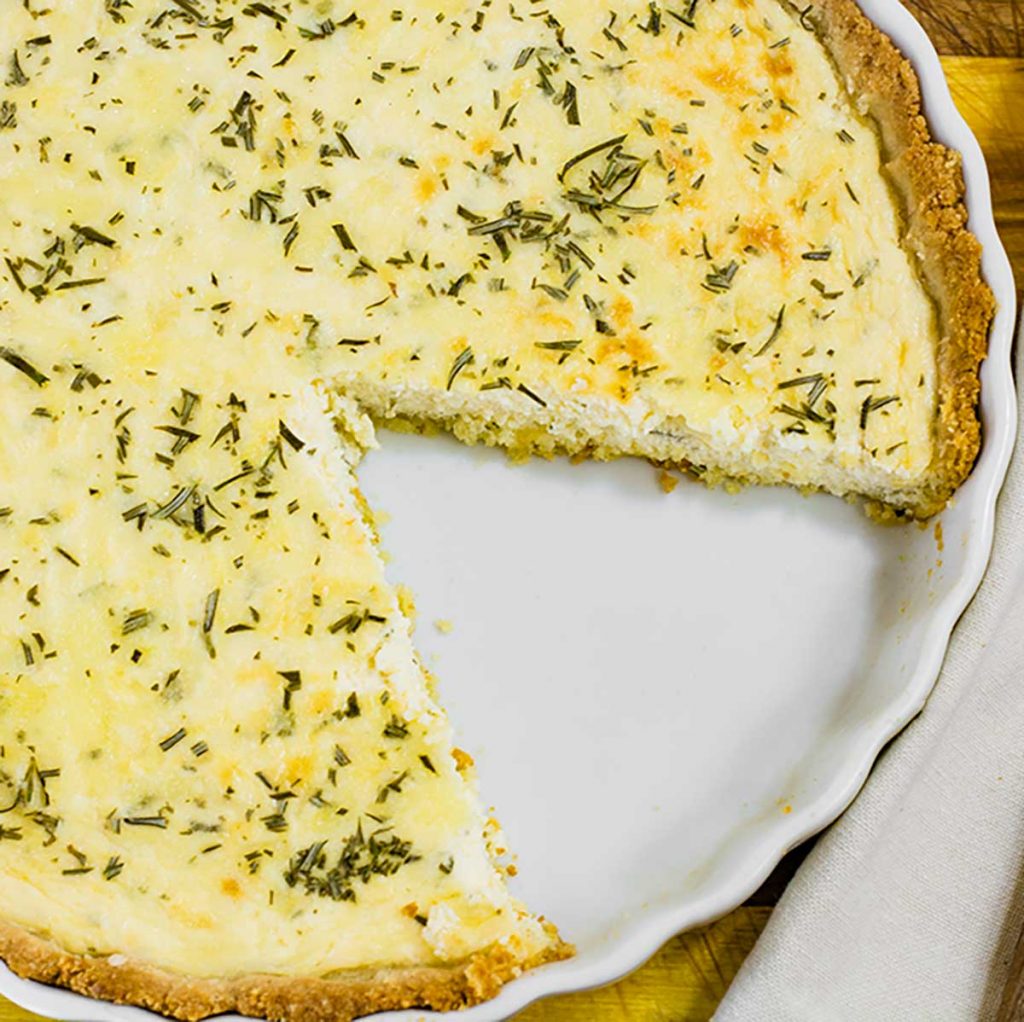 Keto Three Cheese Pie with a slice missing