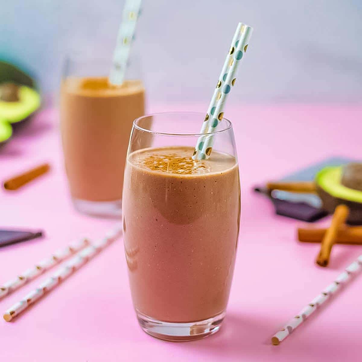 Keto avocado smoothie in a glass and straw.