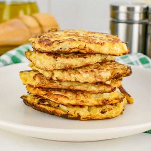 Keto Cabbage Hash Browns stacked on a plate