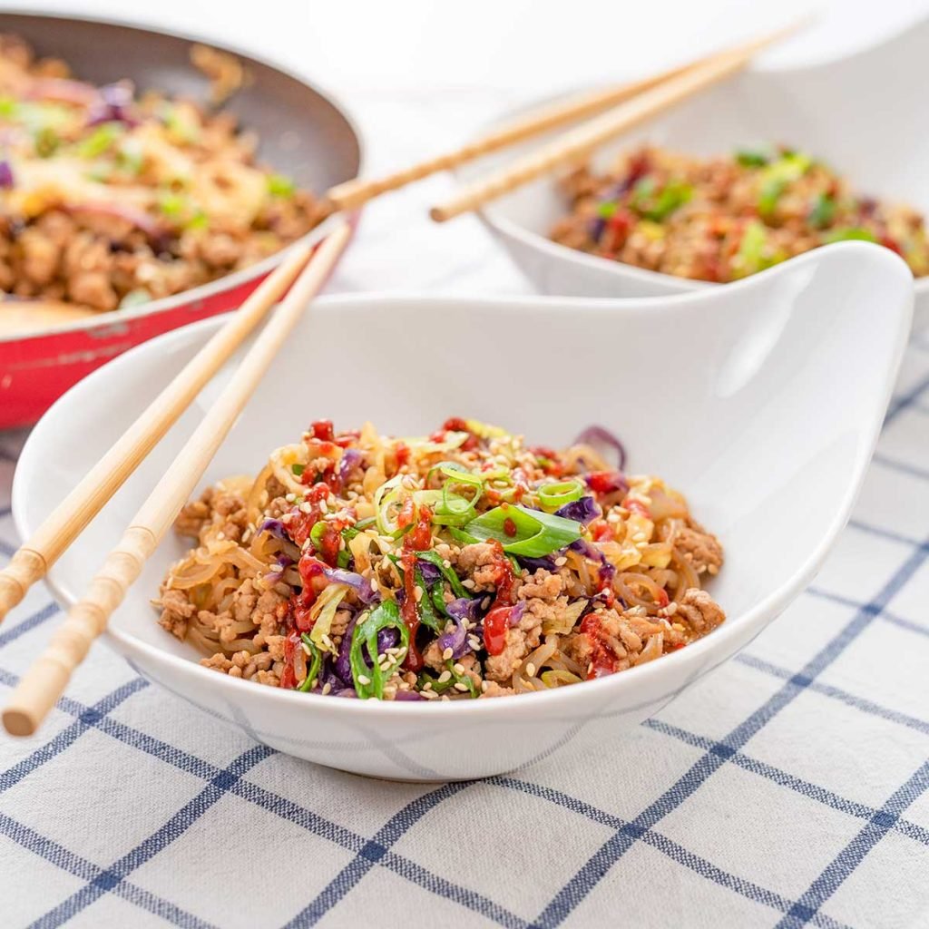 Keto Egg Roll Noodle Bowl in a white bowl on a checked cloth