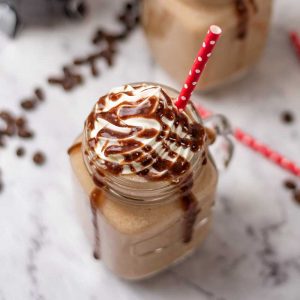 Keto Coffee Frappuccino topped with whipped cream and chocolate sauce in a glass