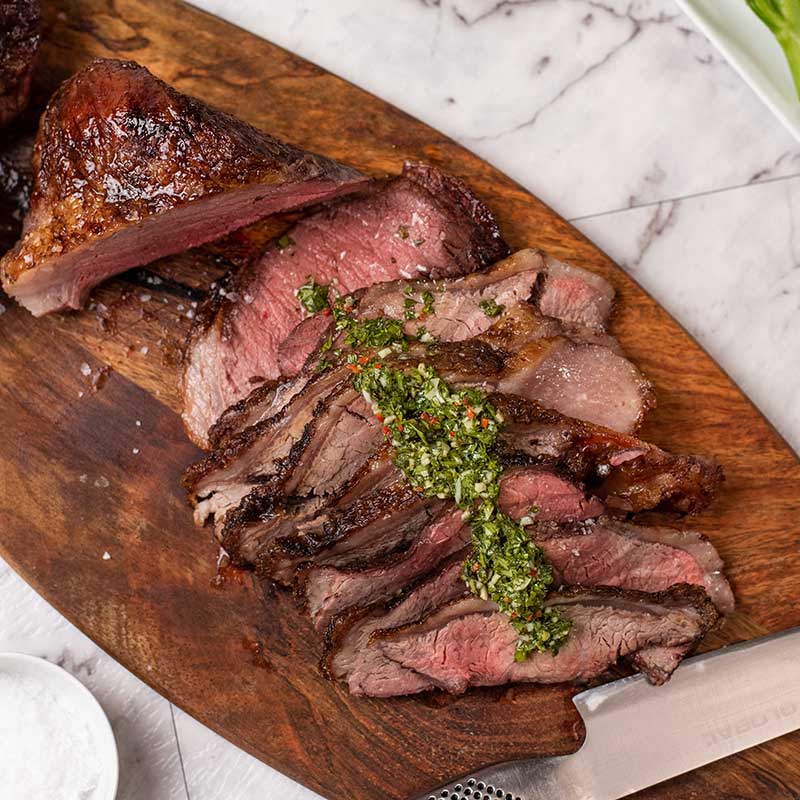 Keto Steak Picanha on a board with chimichurri sauce